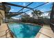 A covered, screened pool has brick coping and updated ladders at 3641 Stokes Dr, Sarasota, FL 34232