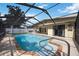 A covered, screened pool has brick coping and steps at 3641 Stokes Dr, Sarasota, FL 34232