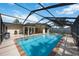 A covered, screened pool has brick coping at 3641 Stokes Dr, Sarasota, FL 34232