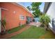 Private backyard featuring lush artificial turf, a charming fountain, and a cozy patio area at 3957 Proctor Rd, Sarasota, FL 34233