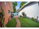 Serene backyard featuring artificial turf, a decorative fountain, and neatly kept landscaping at 3957 Proctor Rd, Sarasota, FL 34233