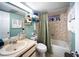 Bathroom including a sink vanity, toilet, and a tub with shower at 3957 Proctor Rd, Sarasota, FL 34233