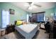 Bedroom featuring a queen-sized bed, ceiling fan, workstation and bright-colored walls at 3957 Proctor Rd, Sarasota, FL 34233