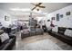 Open concept living room with wood floors, recessed lighting, ceiling fan, and comfortable seating at 3957 Proctor Rd, Sarasota, FL 34233
