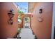 Unique outdoor corridor with a gated archway entrance with decorations along the walls at 3957 Proctor Rd, Sarasota, FL 34233