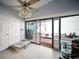 Bright sun room with tile flooring, ceiling fan, closet, and sliding glass door with backyard access at 3957 Proctor Rd, Sarasota, FL 34233