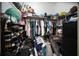 Walk-in closet with shelving racks and hanging space, filled with clothes, shoes and accessories at 3957 Proctor Rd, Sarasota, FL 34233