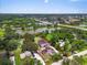 An aerial view showing a pink house with a lake, mature landscaping, and outlined property lines at 4105 37Th E St, Bradenton, FL 34208
