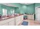 Large bathroom featuring a vanity with 2 sinks, granite countertops, tile floors and mint green walls at 4105 37Th E St, Bradenton, FL 34208