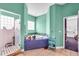 Colorful bathroom featuring a shower with glass door, bath tub with blue tile, and mint green walls at 4105 37Th E St, Bradenton, FL 34208