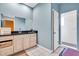 Powder blue bathroom featuring a shower with glass door and a large white vanity with a black countertop at 4105 37Th E St, Bradenton, FL 34208