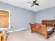 Bedroom features blue walls, a window that is boarded up, and a wood framed bed at 4105 37Th E St, Bradenton, FL 34208