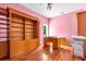 Cozy bedroom with custom built-in shelving and hardwood floors, bathed in natural light at 4105 37Th E St, Bradenton, FL 34208