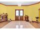 Yellow entryway with tiled floor, chandelier, pink trim, and a double door entrance at 4105 37Th E St, Bradenton, FL 34208