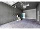 Spacious garage featuring black walls, carpet, overhead lighting and door, and plenty of room for storage at 4105 37Th E St, Bradenton, FL 34208
