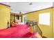 Yellow hallway with red trim, wood railing, glass block, and carpeted floor at 4105 37Th E St, Bradenton, FL 34208