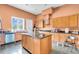 Spacious kitchen with granite countertops, wood cabinets, kitchen island, stainless steel appliances, and tile floor at 4105 37Th E St, Bradenton, FL 34208