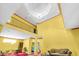 Yellow living room with high ceilings, a chandelier, loft area, red carpet, and tiled floors at 4105 37Th E St, Bradenton, FL 34208