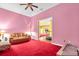 Comfortable pink living room with a plush brown sofa, a Zebra chair, and red carpet at 4105 37Th E St, Bradenton, FL 34208