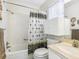Bright bathroom with a shower-tub combo, white cabinets and a sink with a marble countertop at 4203 Schwalbe Dr # 115, Sarasota, FL 34235