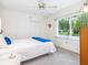 Bedroom features a bed, closet, window with backyard view, and ceiling fan at 4203 Schwalbe Dr # 115, Sarasota, FL 34235