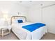 Bright bedroom features a gold bed frame, white bedding and closet at 4203 Schwalbe Dr # 115, Sarasota, FL 34235