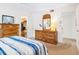 Bright bedroom with a large window, wooden furniture, carpeted floors, and a walk-in closet at 4203 Schwalbe Dr # 115, Sarasota, FL 34235