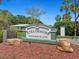 Strathmore Condominiums sign with lush landscaping, offering a welcoming entrance to the community at 4203 Schwalbe Dr # 115, Sarasota, FL 34235
