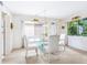 Bright dining room with modern glass table, complemented by natural light and simple decor at 4203 Schwalbe Dr # 115, Sarasota, FL 34235
