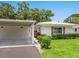 Charming exterior view featuring a carport and well-manicured lawn, blending comfort and curb appeal at 4203 Schwalbe Dr # 115, Sarasota, FL 34235