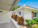 Charming exterior with colorful foliage and a convenient carport, blending style and functionality at 4203 Schwalbe Dr # 115, Sarasota, FL 34235