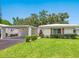 Charming single-story home with a well-maintained lawn and a convenient covered parking area at 4203 Schwalbe Dr # 115, Sarasota, FL 34235