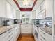 Modern kitchen featuring subway tile backsplash, white cabinets, stainless steel appliances, and granite countertops at 4203 Schwalbe Dr # 115, Sarasota, FL 34235