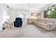 Bright and airy living room featuring plush seating and a large window with a serene outdoor view at 4203 Schwalbe Dr # 115, Sarasota, FL 34235