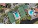 An aerial view showcasing the community's amenities, including tennis courts and a sparkling blue pool at 4411 46Th W Ave # 201, Bradenton, FL 34210