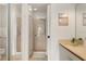 Bathroom with walk-in shower, white vanity, stone countertop, and art hanging above at 4411 46Th W Ave # 201, Bradenton, FL 34210