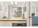 Bathroom features vanity with faux stone countertop, sliding mirror, and coastal decorations at 4411 46Th W Ave # 201, Bradenton, FL 34210