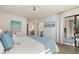 Bedroom with a queen bed, art wall decor, and access to a bathroom and lanai at 4411 46Th W Ave # 201, Bradenton, FL 34210