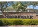 Inviting stone sign for Shorewalk community featuring lush landscaping and a glimpse of the well-maintained homes beyond at 4411 46Th W Ave # 201, Bradenton, FL 34210