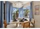 Cozy dining area with chandelier, views and seating for four near blue curtains at 4411 46Th W Ave # 201, Bradenton, FL 34210