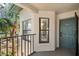 Inviting condo entrance with a blue door, window, and charming balcony view at 4411 46Th W Ave # 201, Bradenton, FL 34210