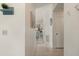 Hallway with tiled floor leading to living room with modern furniture and decor at 4411 46Th W Ave # 201, Bradenton, FL 34210