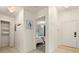 Hallway with tile flooring leads to a bedroom, featuring a storage closet at 4411 46Th W Ave # 201, Bradenton, FL 34210