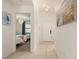 Bright hallway with tile flooring leads to a bedroom with two twin beds at 4411 46Th W Ave # 201, Bradenton, FL 34210