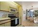 Efficient kitchen with stainless steel appliances conveniently located next to a bright dining area at 4411 46Th W Ave # 201, Bradenton, FL 34210