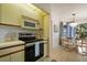 Updated kitchen with stainless appliances, seamlessly connected to the dining area, perfect for entertaining guests at 4411 46Th W Ave # 201, Bradenton, FL 34210
