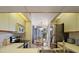Well-lit kitchen featuring sleek appliances and an adjacent dining area with a chandelier and view at 4411 46Th W Ave # 201, Bradenton, FL 34210