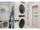 Laundry room with stacked washer and dryer and wire shelving at 4411 46Th W Ave # 201, Bradenton, FL 34210