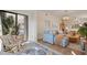 Open living space with indoor-outdoor flow to balcony and comfortable seating arrangements at 4411 46Th W Ave # 201, Bradenton, FL 34210