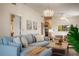 Comfortable living room with plush seating, chandelier and access to other rooms in the condo at 4411 46Th W Ave # 201, Bradenton, FL 34210